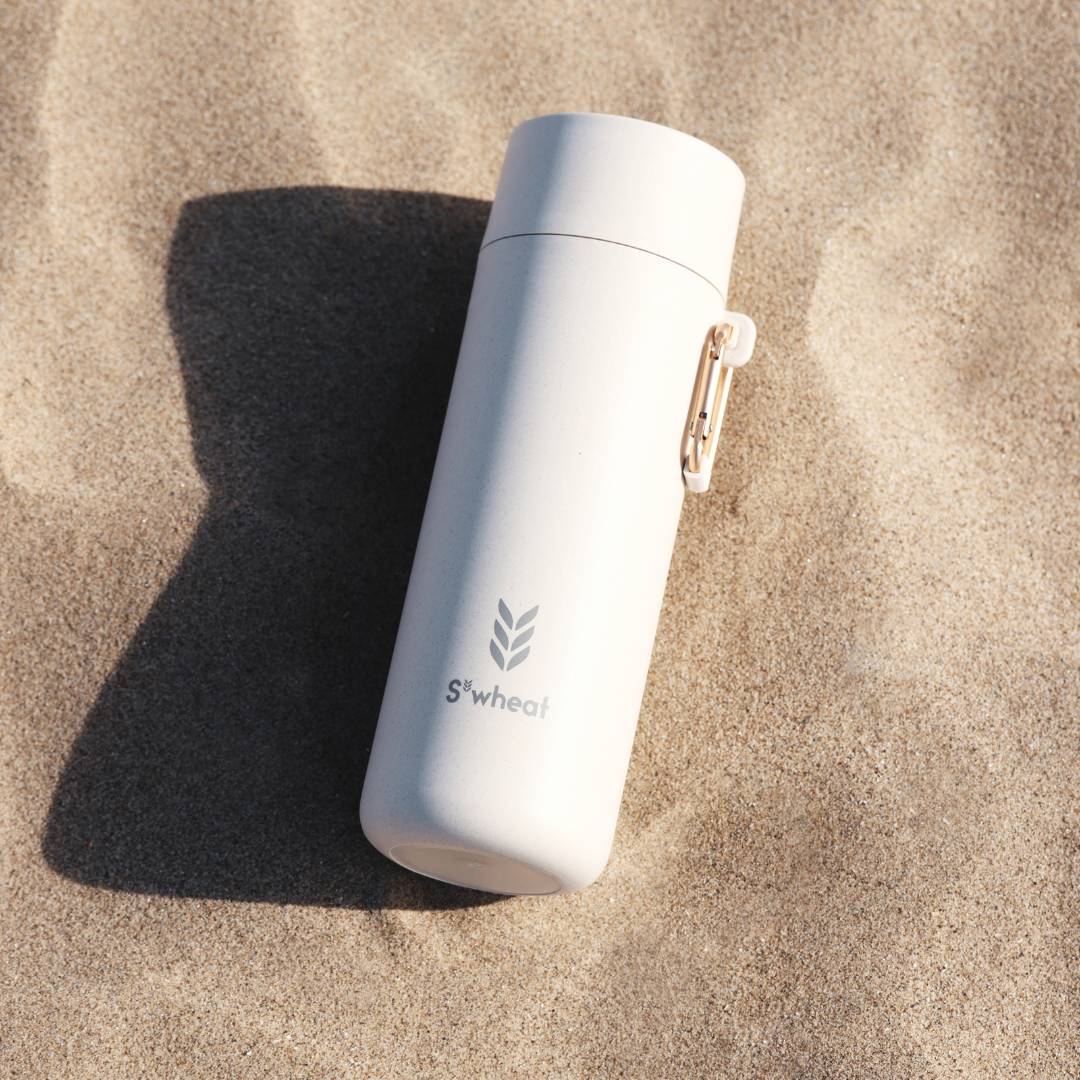 Eco-friendly bottle on top of sand